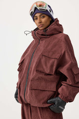Chaqueta de nieve de pana impermeable de color rojo ladrillo con mangas de murciélago y bolsillo grande para mujer